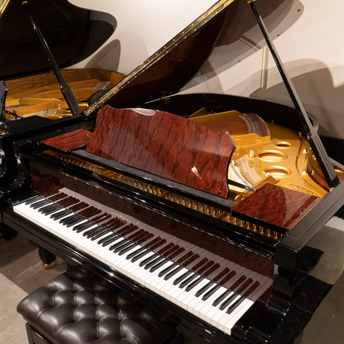 Exquisite handcrafted grand piano with polished ebony finish and premium quality wood, showcasing superior soundboard design.