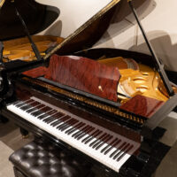 Exquisite handcrafted grand piano with polished ebony finish and premium quality wood, showcasing superior soundboard design.