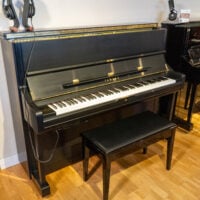 Yamaha upright piano with bench, sleek black finish, available at Classic Pianos Denver. Perfect for home or studio.