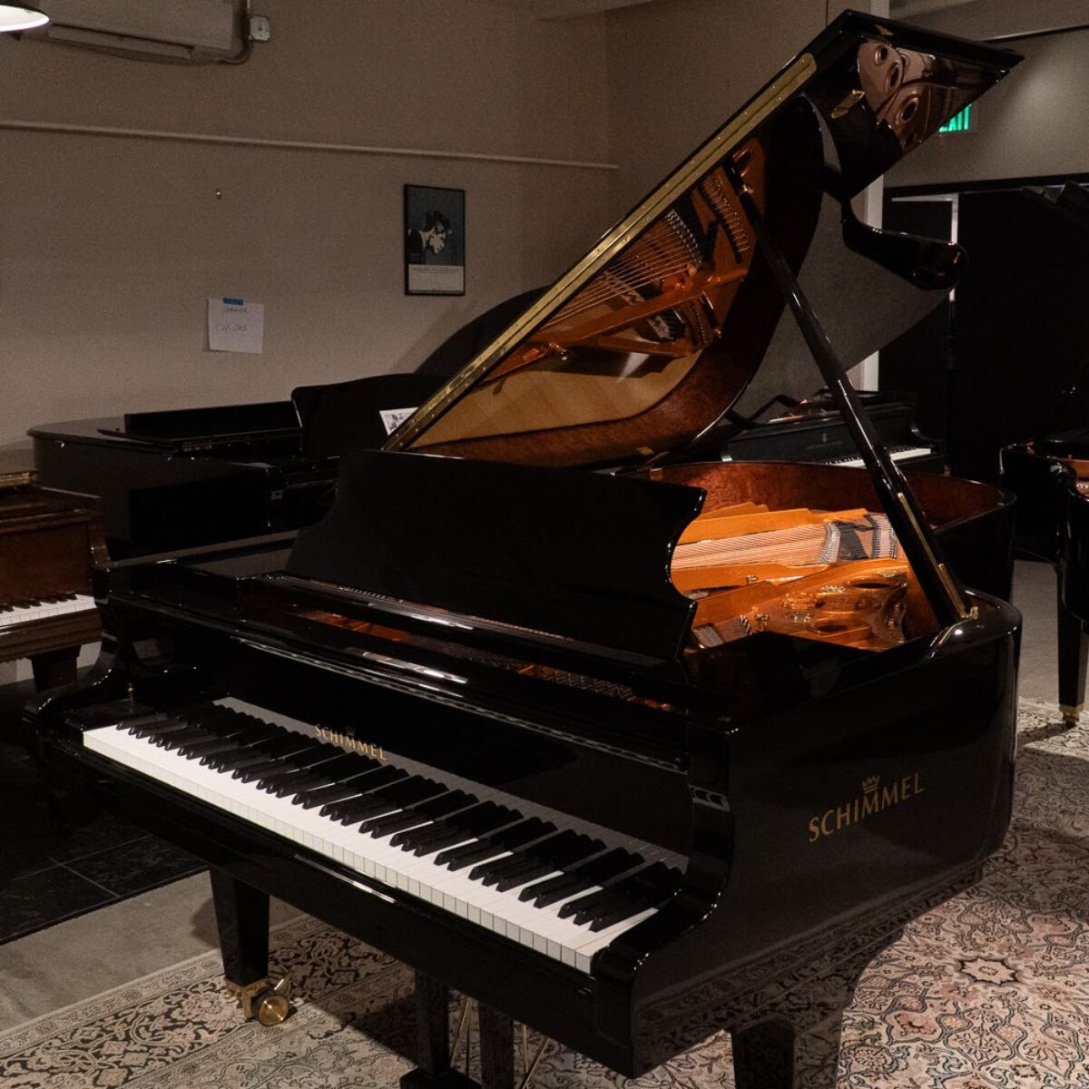Schimmel grand piano in polished black, showcasing premium craftsmanship at Classic Pianos Denver showroom.