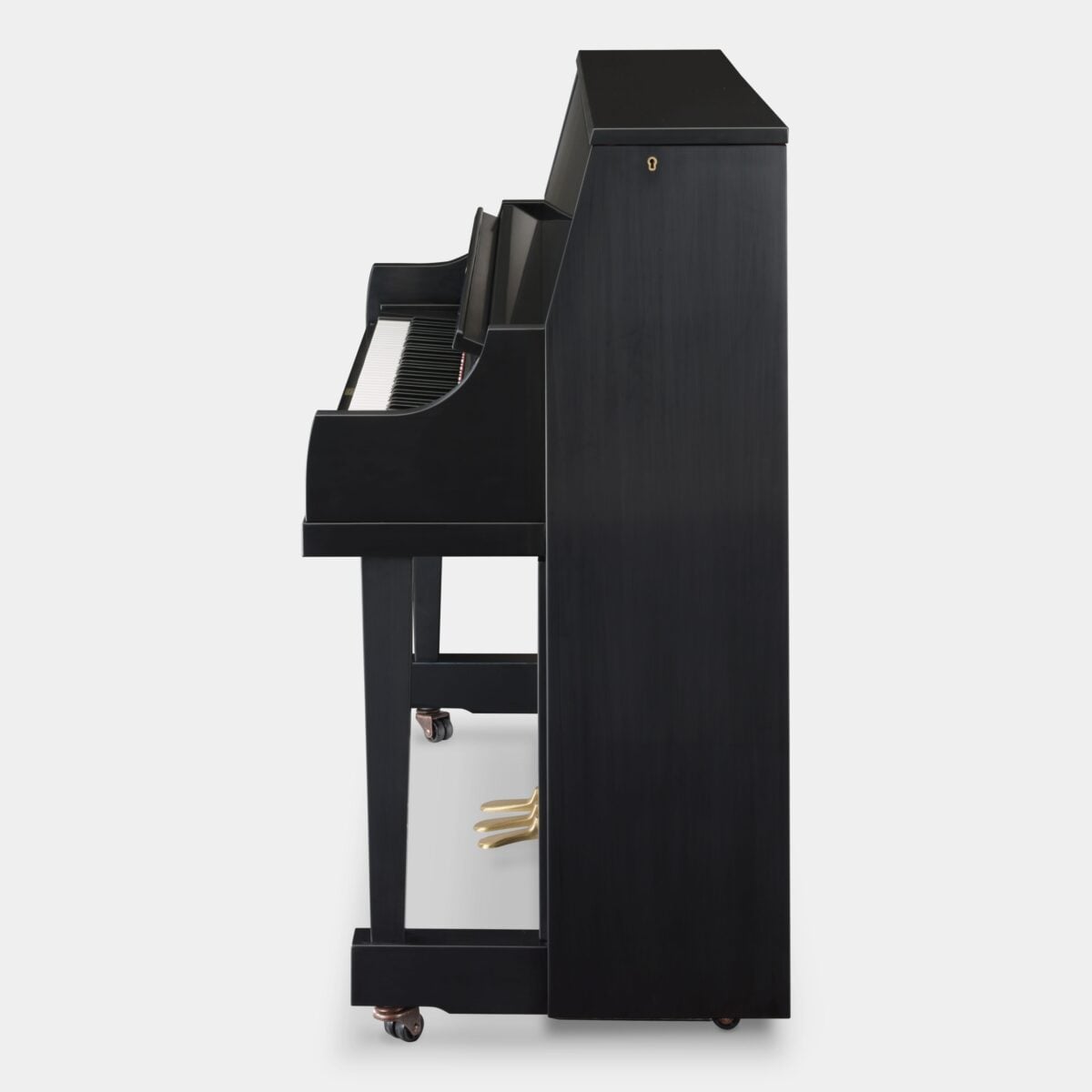 Profile view of a sleek black upright piano, showcasing elegant finish and craftsmanship. Ideal for modern interiors.
