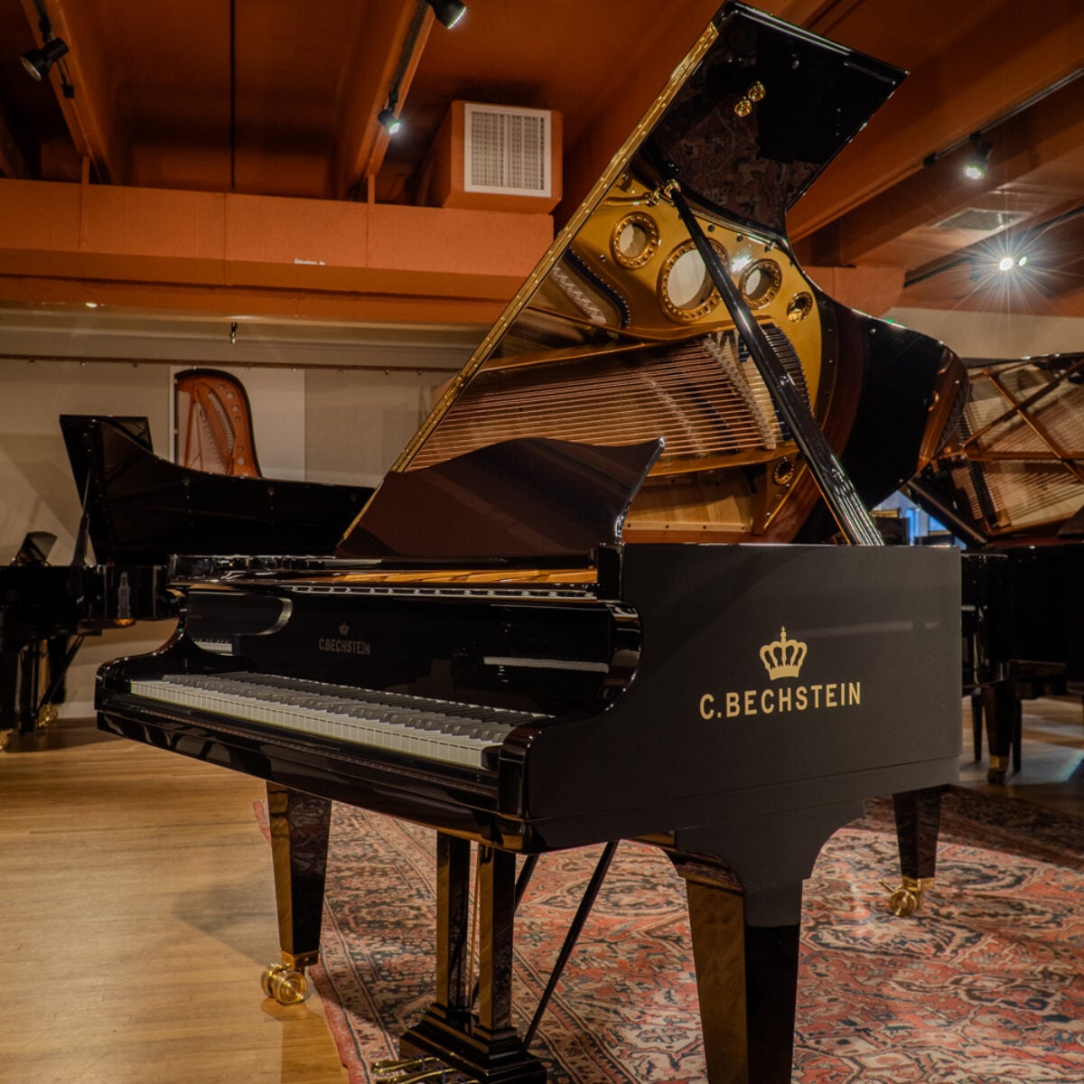 C. Bechstein grand piano featuring premium ebony finish and traditional craftsmanship for exceptional sound quality.