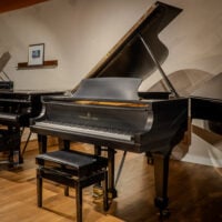 Steinway & Sons grand piano in satin black finish, showcasing expert craftsmanship and premium materials at Classic Pianos Denver.