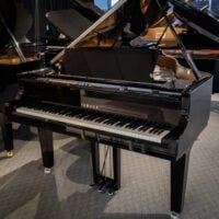 Yamaha grand piano with polished ebony finish, featuring responsive keys and high-quality sound for any performance setting.