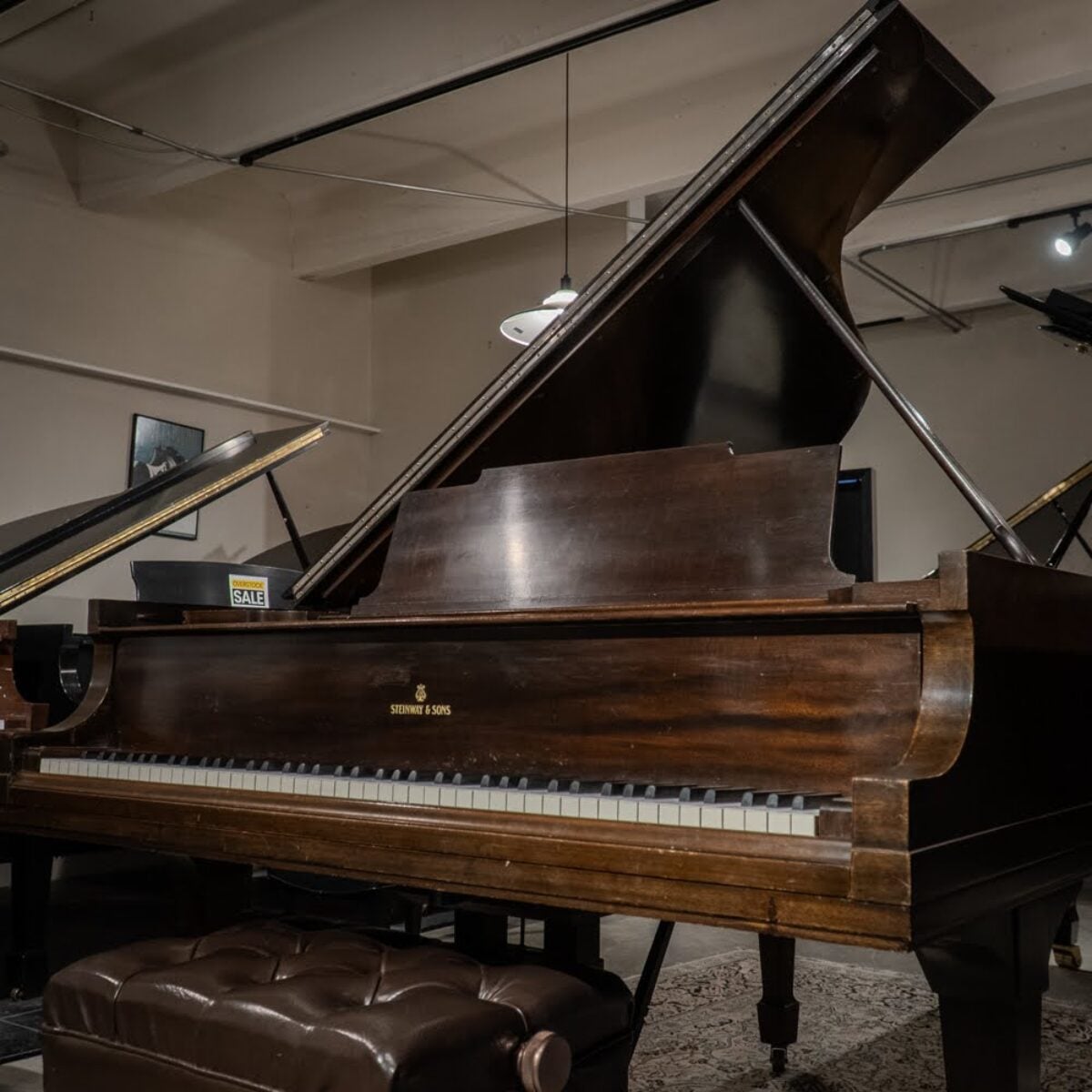 Alt text: Steinway & Sons grand piano with rich mahogany finish, showcasing craftsmanship and premium sound quality at Classic Pianos.