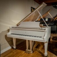 Alt text: Elegant Steinway & Sons grand piano in sleek white finish, showcasing premium craftsmanship and stunning aesthetic appeal.