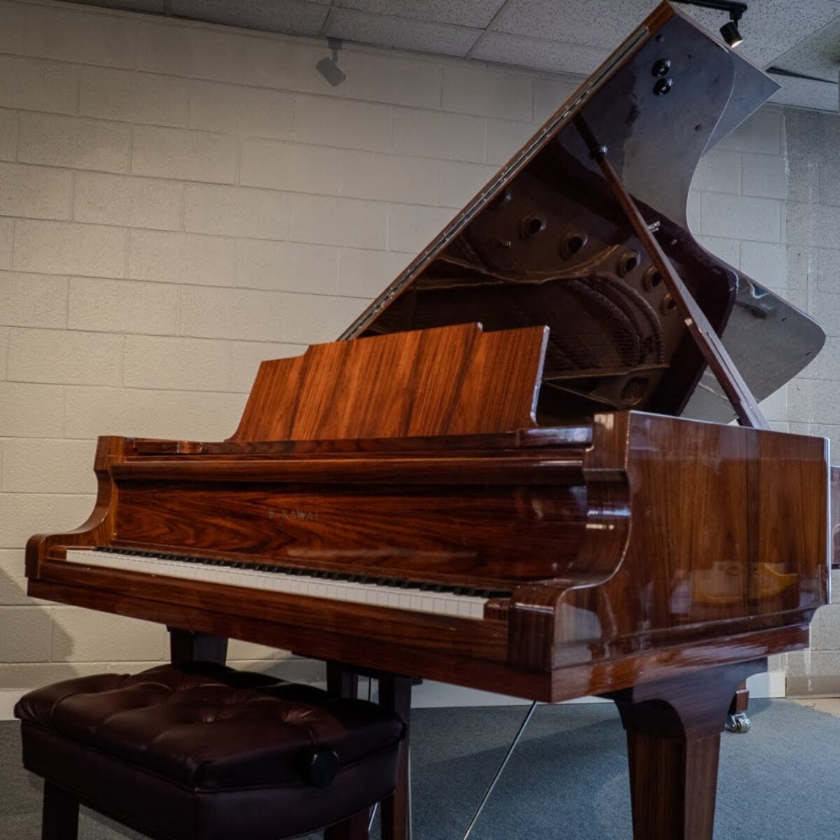 Elegant Kawai grand piano with polished mahogany finish and premium ivory keys, perfect for any music enthusiast.