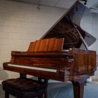 Elegant Kawai grand piano with polished mahogany finish and premium ivory keys, perfect for any music enthusiast.