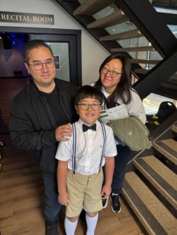 Family visiting Classic Pianos, exploring premium grand and upright pianos in the Recital Room at Denver showroom.