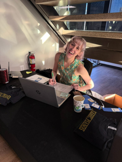 Sales representative engaging customers at Classic Pianos, showcasing premium pianos and accessories in a vibrant setting.