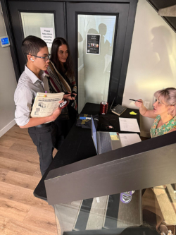 Customer consultation at Classic Pianos showroom, discussing quality pianos and services for aspiring musicians.