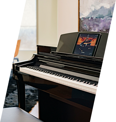 Digital piano with player interface at Classic Pianos Denver showroom. Sleek black finish and modern features.