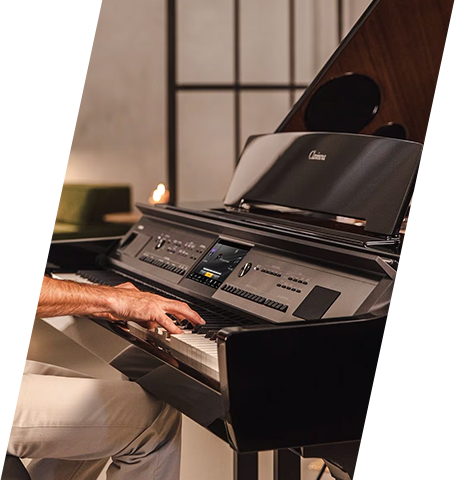 Playing the Yamaha AvantGrand NU1X hybrid piano with polished ebony finish at Classic Pianos Denver showroom.
